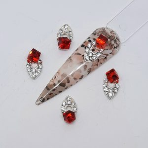 sparkly nail charms with gems and a red cube